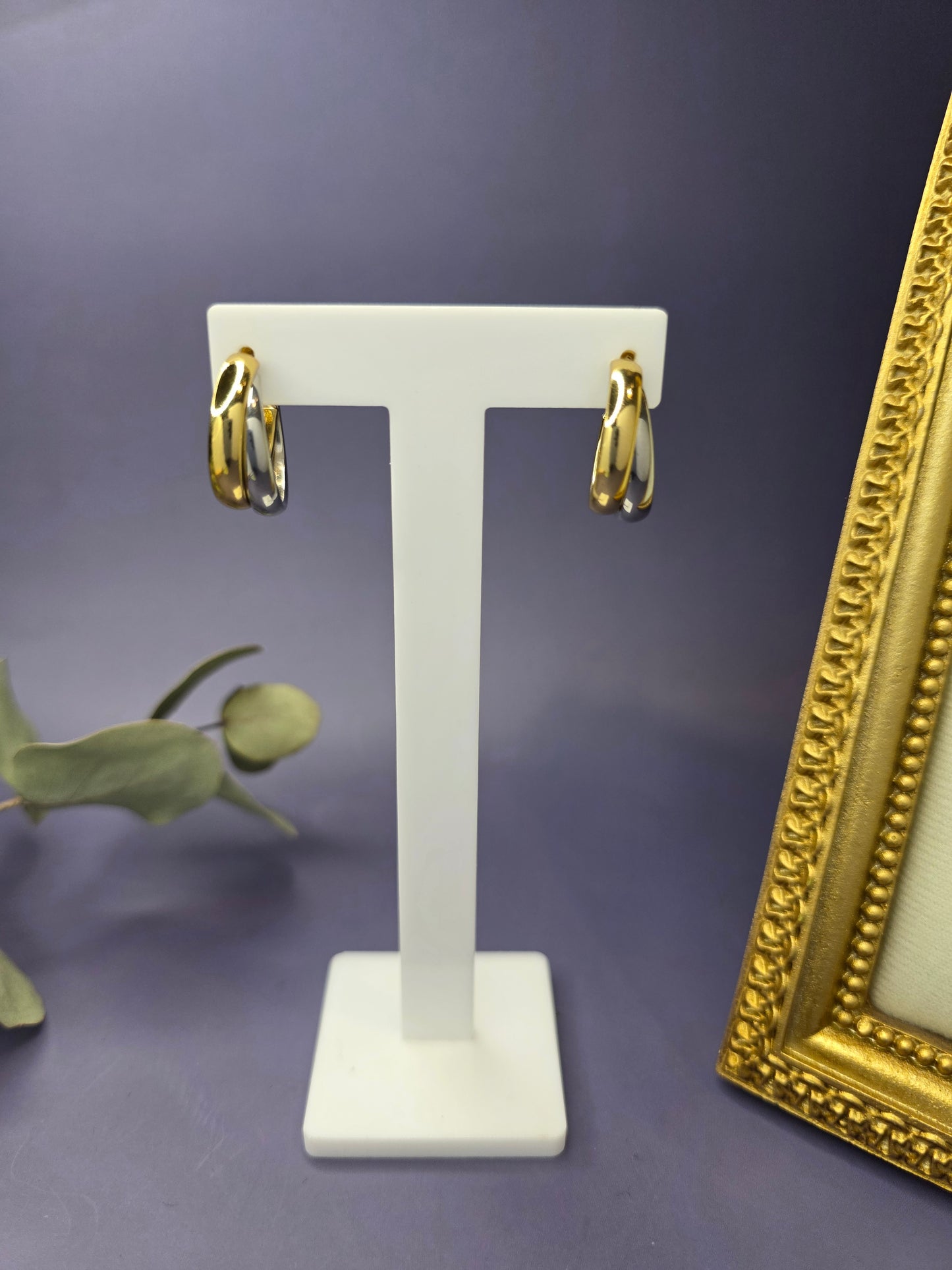 Front view of Gemini Half Hoops on a white stand, showcasing the striking 18K gold-plated and silver-tone layered design. These chunky, mixed-metal earrings are tarnish-resistant and hypoallergenic - My Silver Lining.