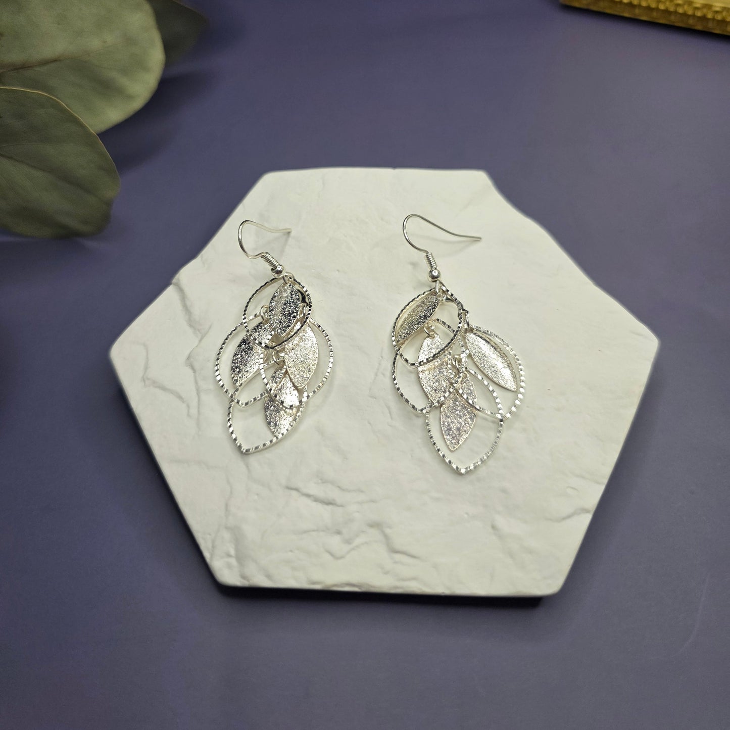 Silver Glitzy Leaf Earrings on a textured stone flat lay — My Silver Lining.