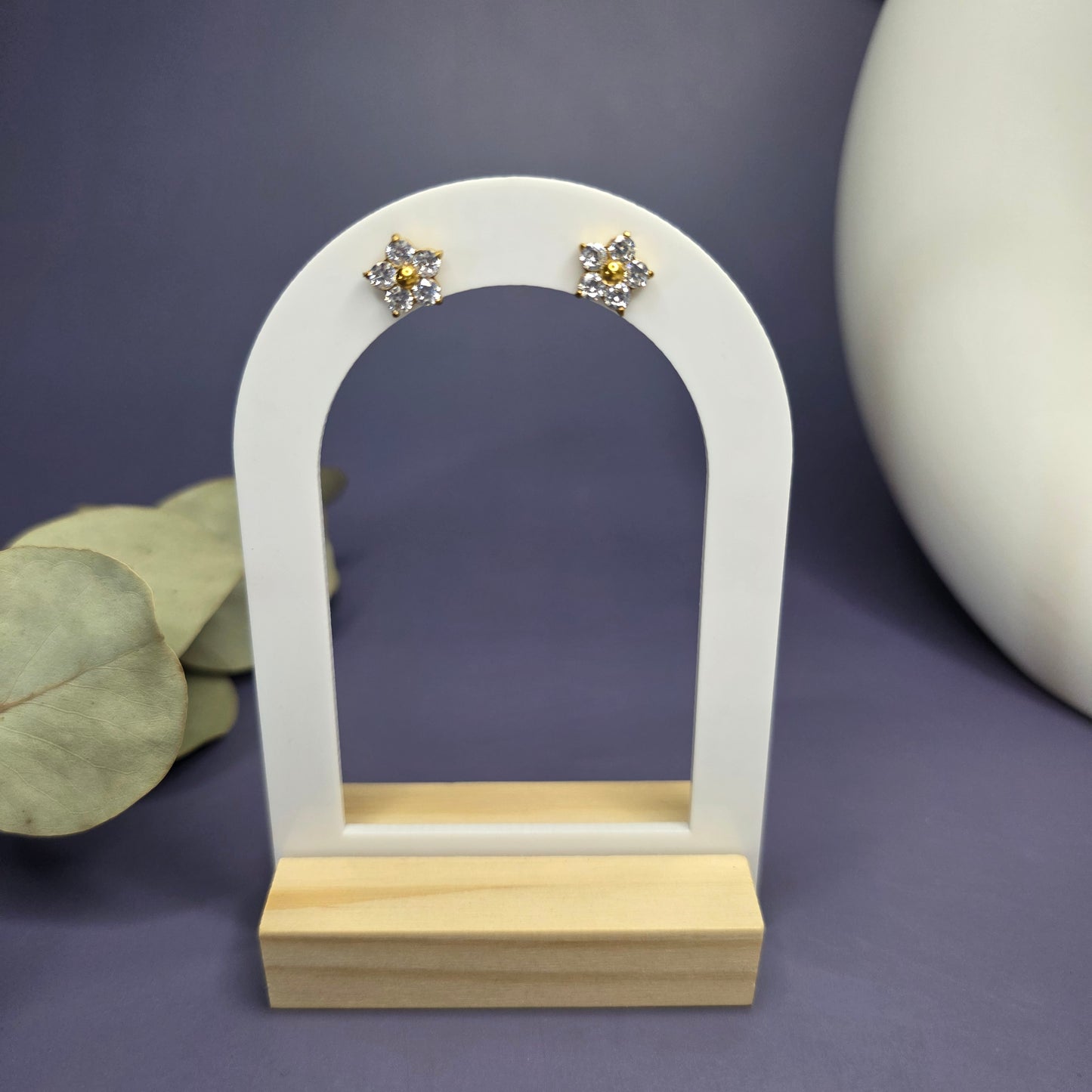 SEO optimized angled shot of the floral zircon studs on a white display stand, showcasing their $1\text{ cm}$ size — My Silver Lining.