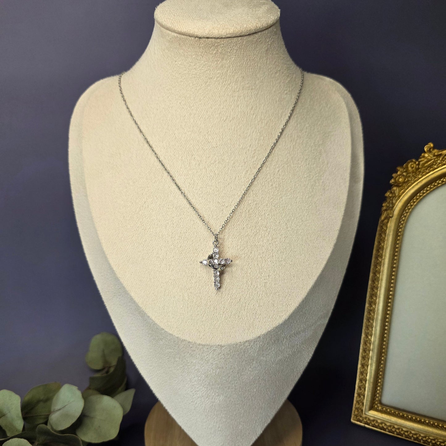 Silver Glimmering Grace cross necklace on a jewelry bust — My Silver Lining.