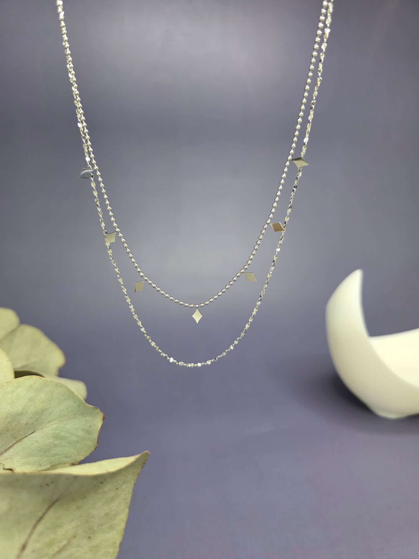 Silver Diamond-Drop Duo necklace shown floating to highlight the 2-layer silver satellite chain and polished geometric charms. Tarnish-resistant stainless steel jewelry - My Silver Lining.
