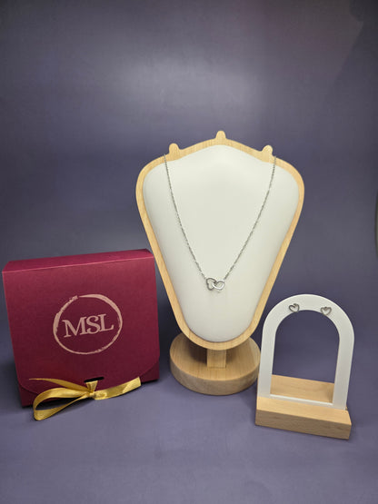 Valentine’s Day gift set featuring a silver dual interlocking heart necklace and dainty Cupido heart stud earrings by My Silver Lining.