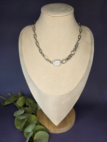 My Silver Lining silver necklace on a display bust, showcasing a pendant made of a genuine freshwater baroque pearl and a tarnish-resistant silver chain.