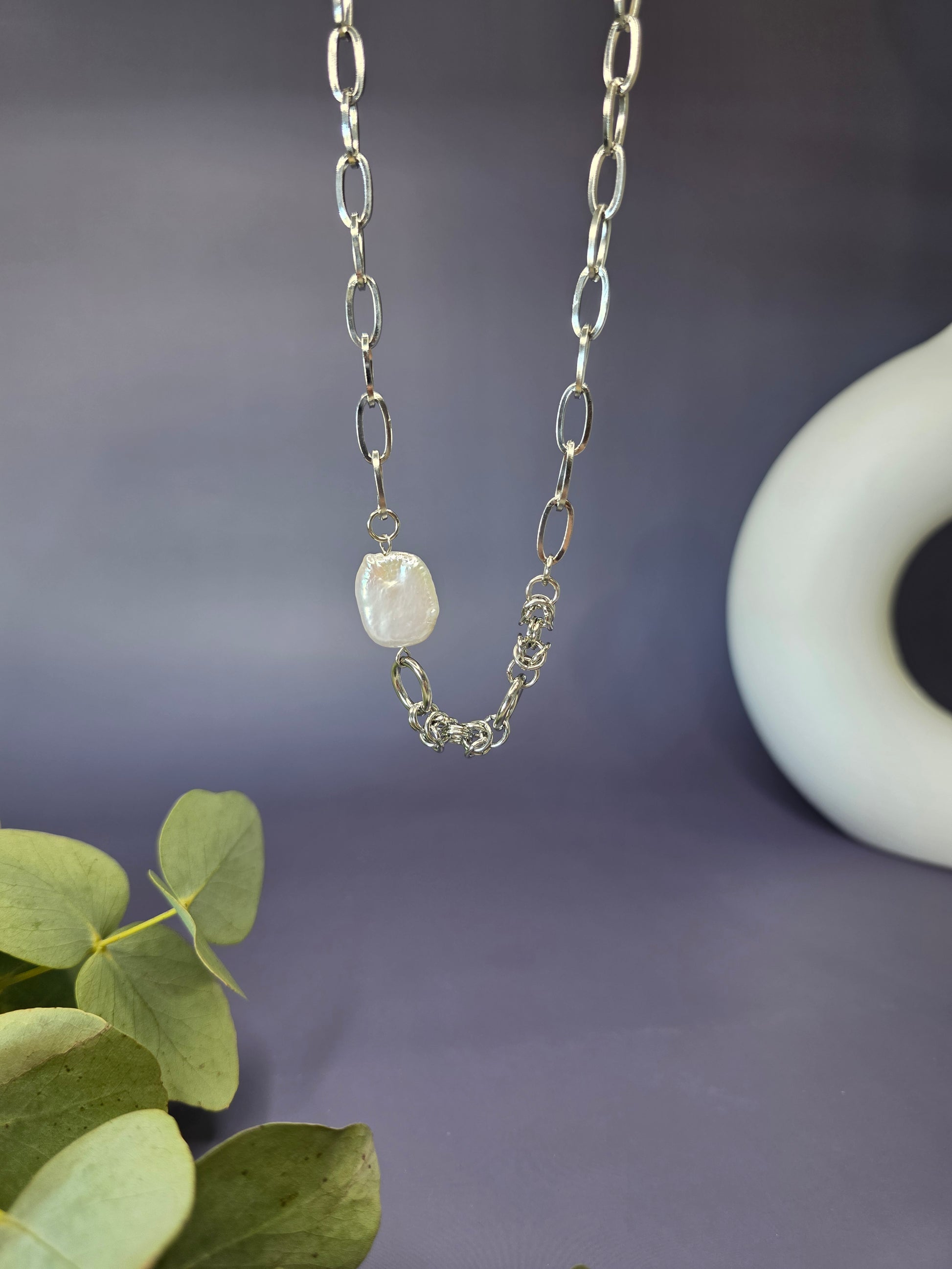 Close-up of waterproof jewelry by My Silver Lining, featuring a high-quality silver chain and a unique pearls centerpiece with a brilliant, polished finish.