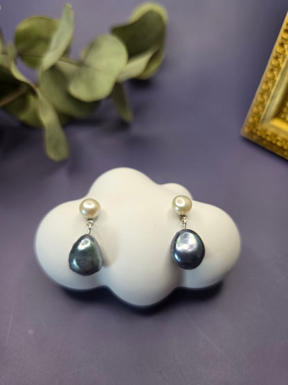 Black Moon Drops displayed on a white cloud stone. These genuine black baroque freshwater pearl earrings feature a white pearl stud and stainless steel needles - My Silver Lining.