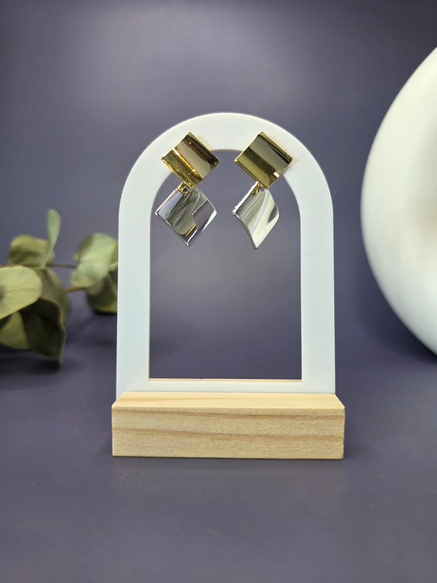 Duo-Tone Geometry drops featured on a white arch jewelry stand. These bold geometric mixed metal earrings provide a modern architectural silhouette and hypoallergenic finish - My Silver Lining.
