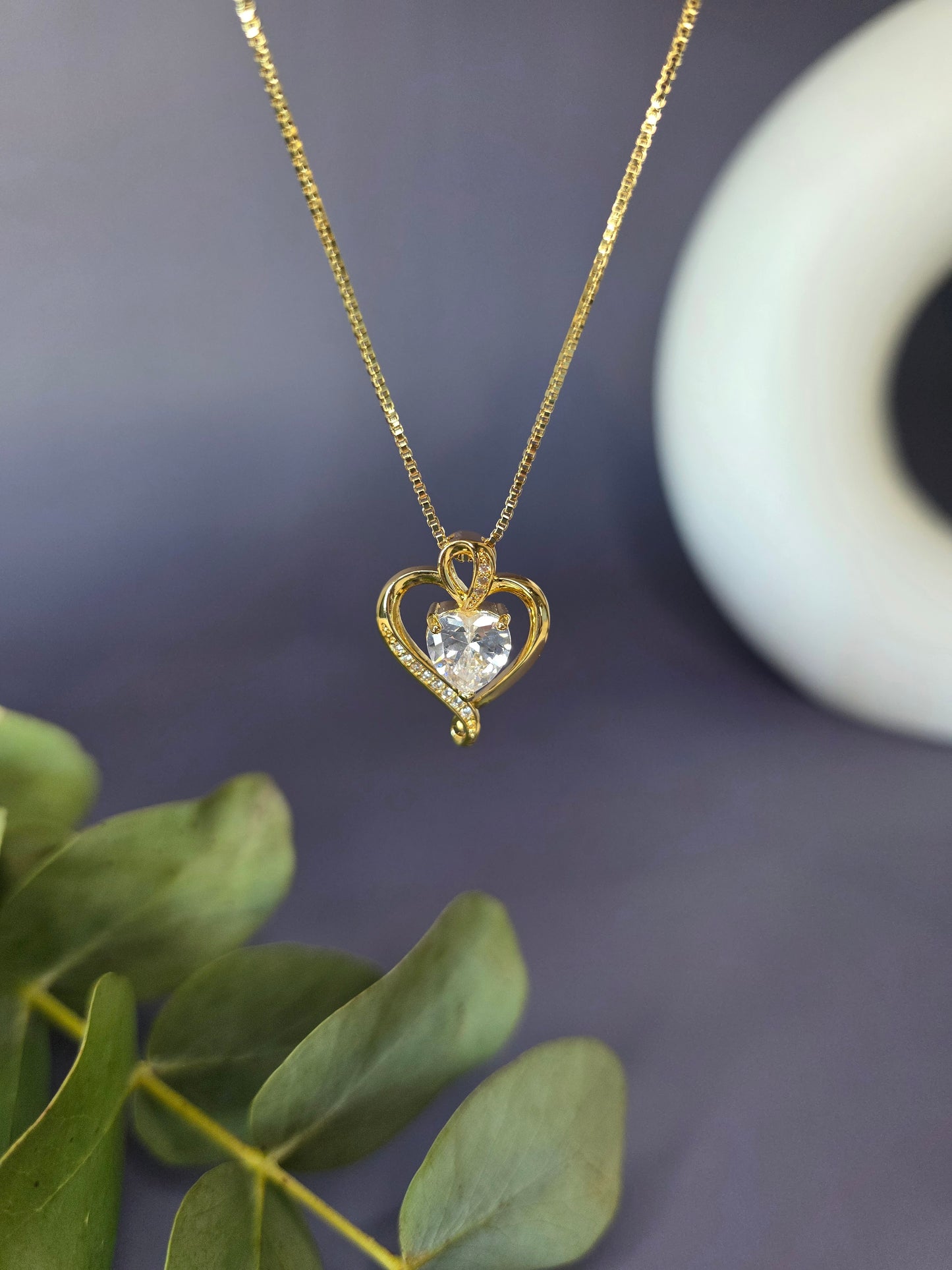 Eternal Heart Solitaire necklace featuring an 18K gold-plated open heart frame and a brilliant faceted cubic zirconia stone center that captures light beautifully - My Silver Lining.