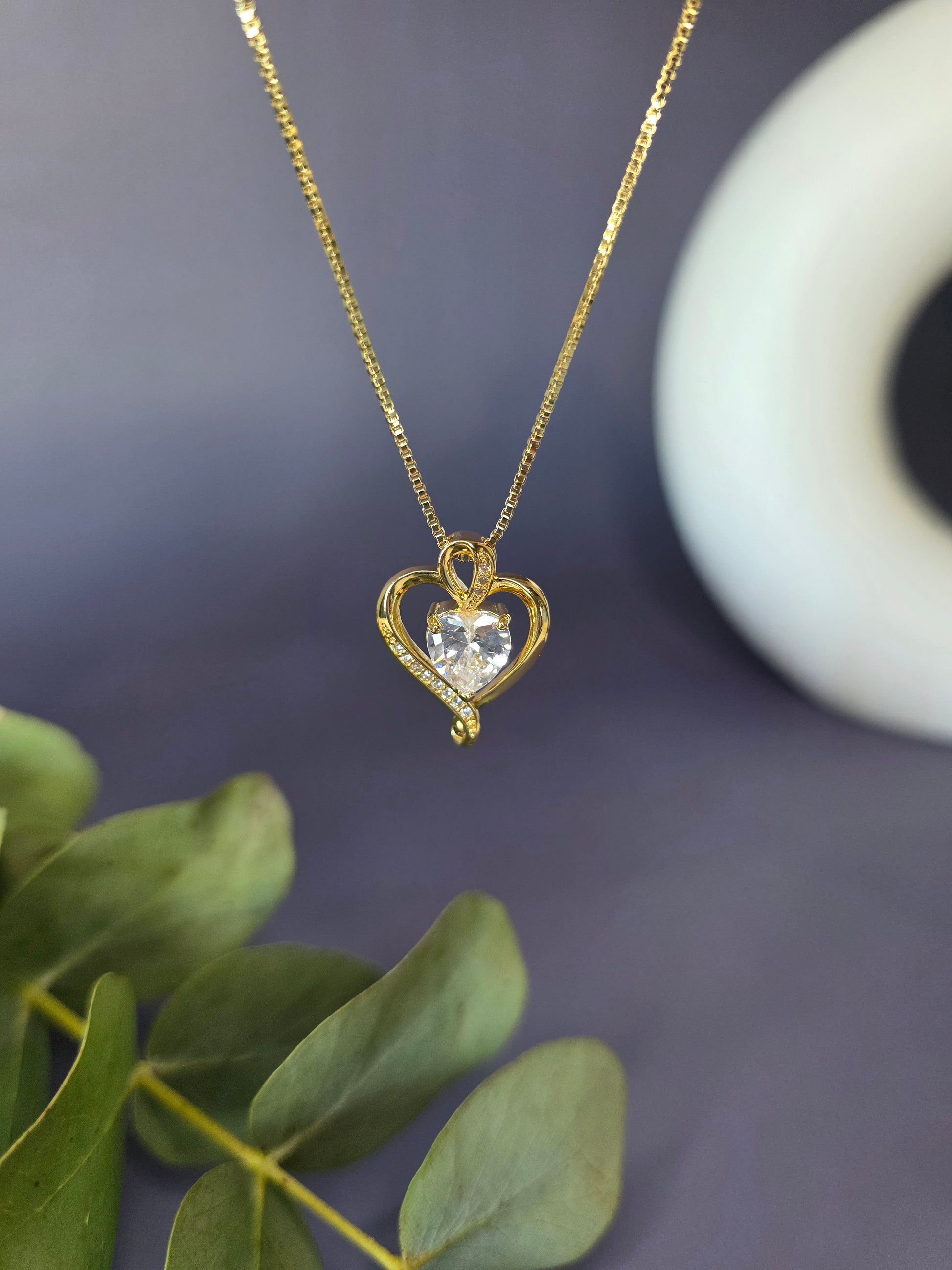 Eternal Heart Solitaire necklace featuring an 18K gold-plated open heart frame and a brilliant faceted cubic zirconia stone center that captures light beautifully - My Silver Lining.