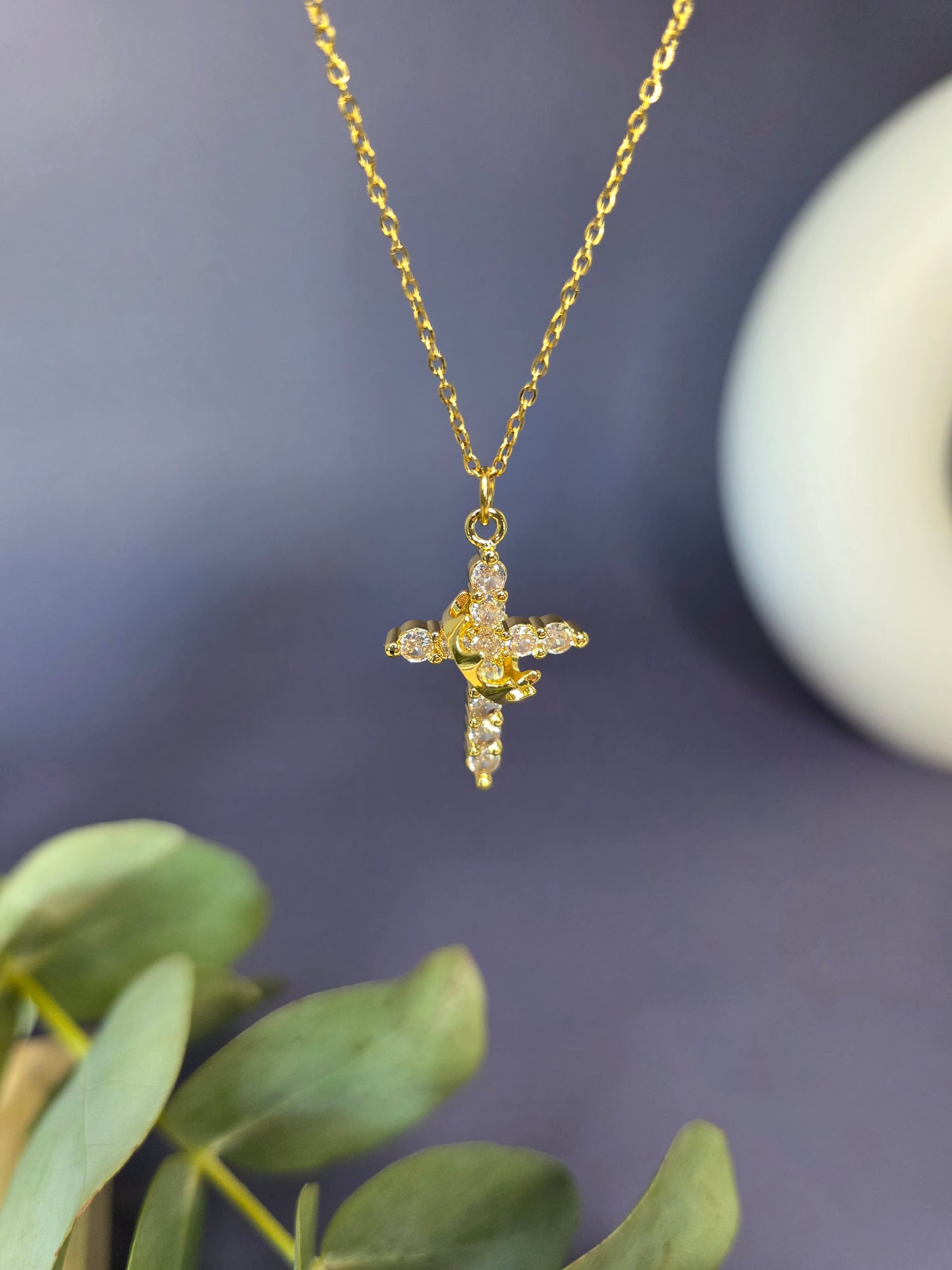 Glimmering Gold Grace necklace shown floating to highlight the 18K gold plating and pave-set stones. Tarnish-resistant gold cross for sensitive skin - My Silver Lining.