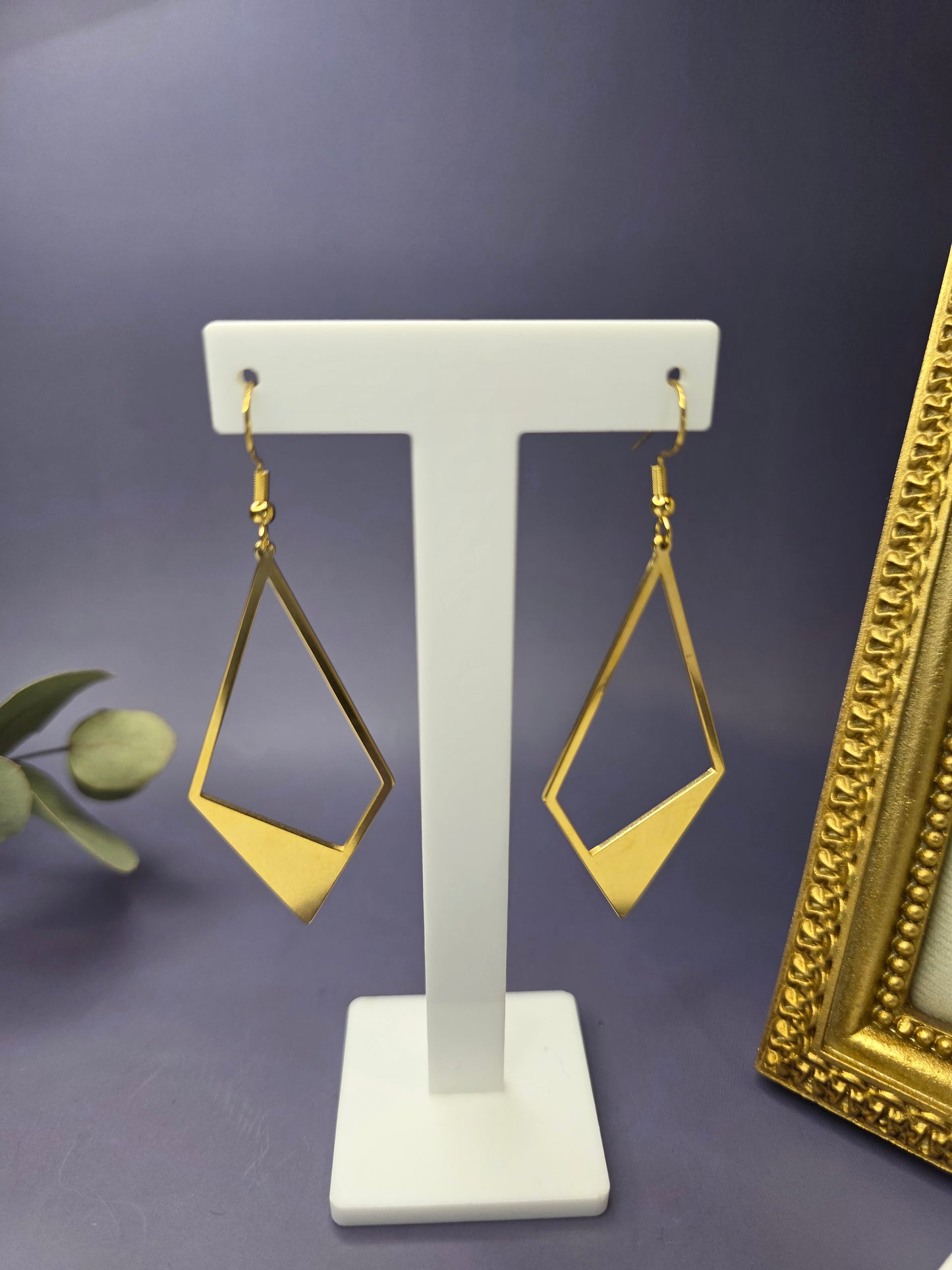 Golden Anchor Drops showcased on a white T-stand. These 7.4cm elongated kite earrings feature a bold geometric design in pvd gold-plated stainless steel - My Silver Lining.