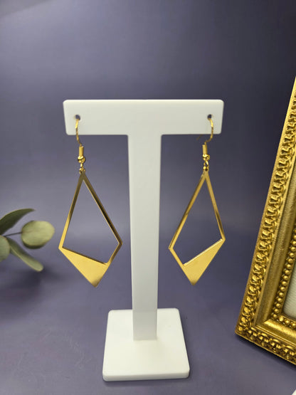 Golden Anchor Drops showcased on a white T-stand. These 7.4cm elongated kite earrings feature a bold geometric design in pvd gold-plated stainless steel - My Silver Lining.