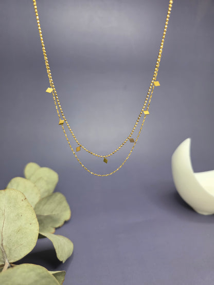 Golden Diamond-Drop Duo necklace shown floating to highlight the 2-layer satellite chain and polished geometric charms. Tarnish-resistant gold jewelry - My Silver Lining.