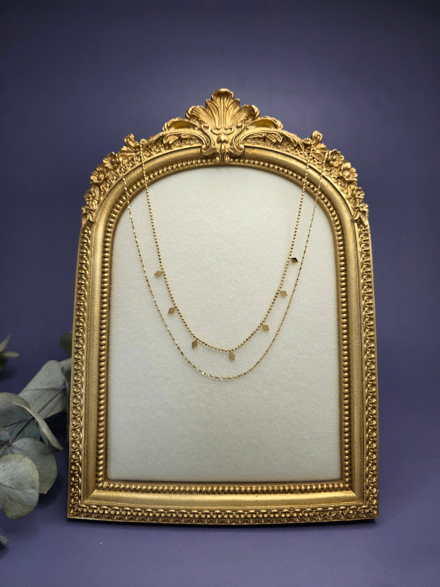 Golden Diamond-Drop Duo layered necklace styled on a golden frame. This 18K gold plated 316 stainless steel necklace features satellite beads and diamond charms - My Silver Lining.