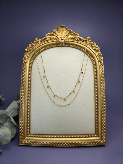 Golden Diamond-Drop Duo layered necklace styled on a golden frame. This 18K gold plated 316 stainless steel necklace features satellite beads and diamond charms - My Silver Lining.