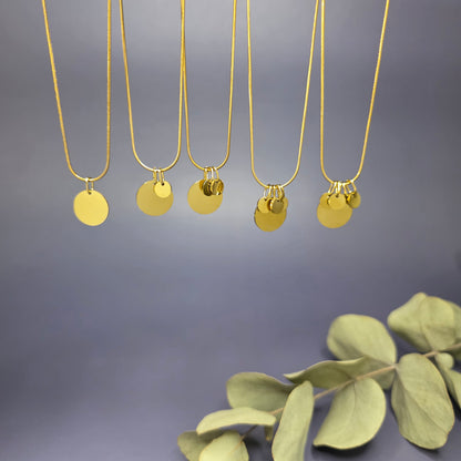View of the five variants of the Golden Mamma Bear necklace, showing the 1.3cm main pendant with varying numbers of 0.6cm initial discs — My Silver Lining.