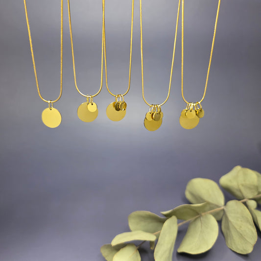 View of the five variants of the Golden Mamma Bear necklace, showing the 1.3cm main pendant with varying numbers of 0.6cm initial discs — My Silver Lining.