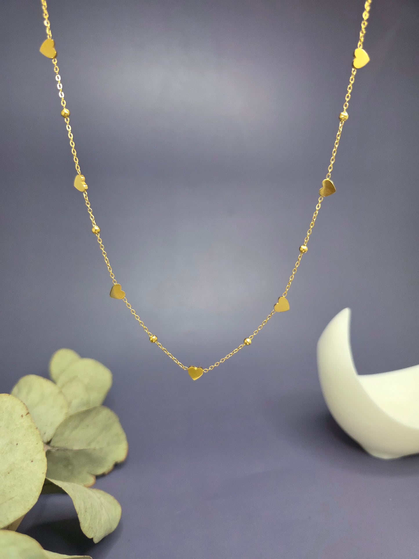 Golden Rhythm Heart necklace shown floating to highlight the rhythmic heart charms. Tarnish-resistant 18K gold plated jewelry for sensitive skin - My Silver Lining.