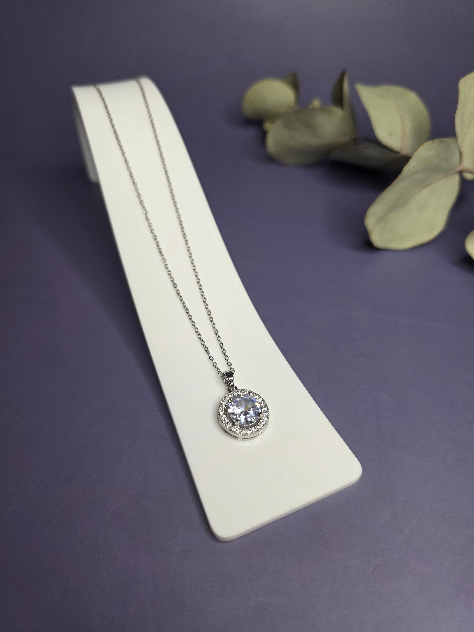 Angled view of the Grand Gala Sparkle Necklace in polished stainless steel with a zircon halo — My Silver Lining.