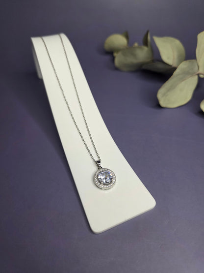 Angled view of the Grand Gala Sparkle Necklace in polished stainless steel with a zircon halo — My Silver Lining.