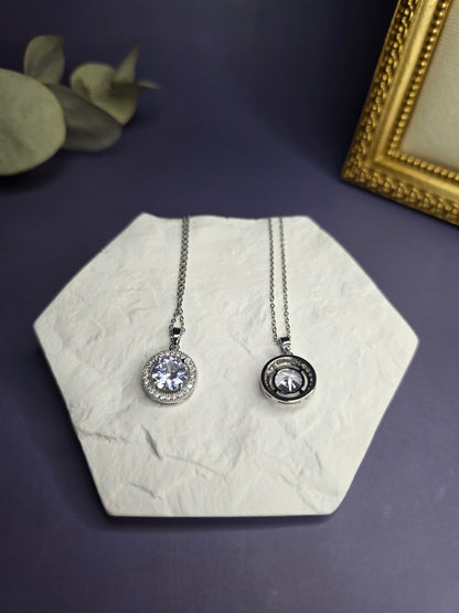 Top-down view of the Grand Gala Sparkle Necklace alongside a matching silver zircon piece on a white textured hexagon display — My Silver Lining.