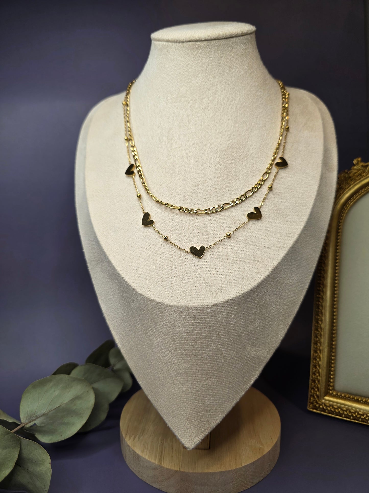 The Heartfelt Journey necklace displayed on a jewelry bust to show the tangle-free layered design. A waterproof and tarnish-resistant gold heart necklace crafted for modern style - My Silver Lining.