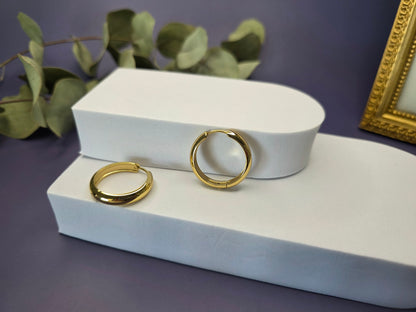 Line of Luxe hoops displayed on a white foam stellation. These 2.5cm 18K gold plated waterproof earrings made of 304 stainless steel feature a wide huggie design - My Silver Lining.