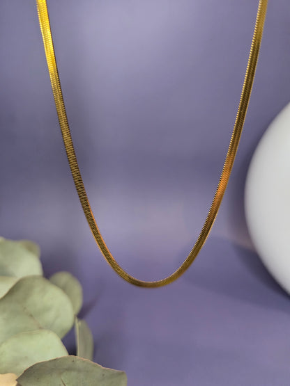 Liquid Gold Snake Chain necklace shown floating to highlight the seamless flat herringbone links. Tarnish-resistant 18K gold plating with 40cm adjustable length - My Silver Lining.