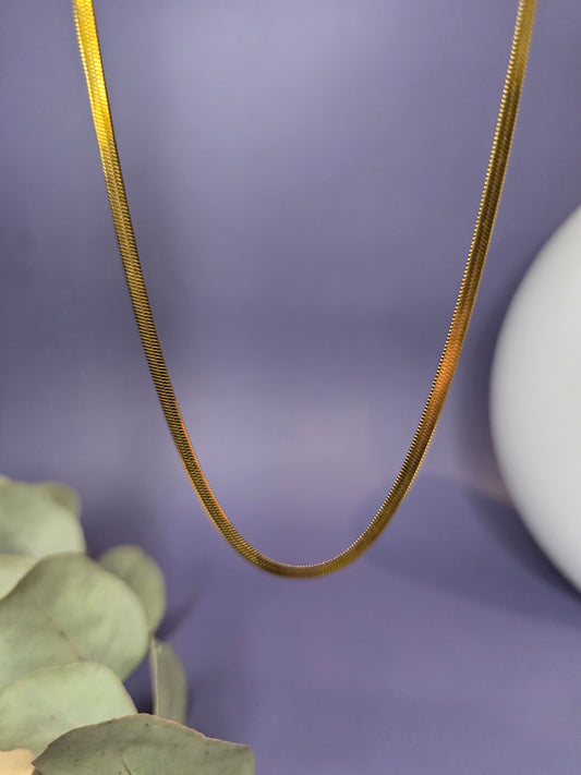 Liquid Gold Snake Chain necklace shown floating to highlight the seamless flat herringbone links. Tarnish-resistant 18K gold plating with 40cm adjustable length - My Silver Lining.