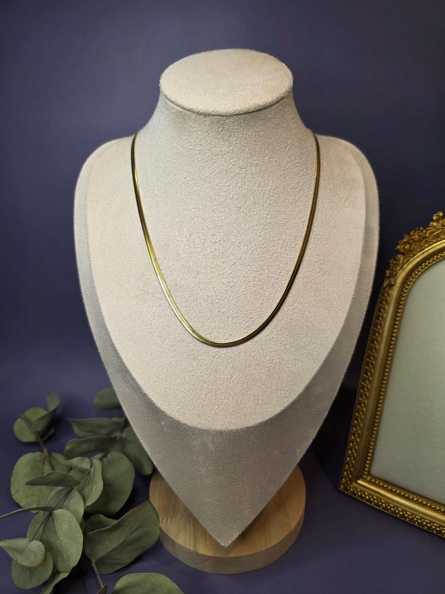 Liquid Gold Snake Chain necklace styled on a white jewelry bust. This 18K gold plated herringbone necklace showcases a fluid, liquid-like drape and high-shine finish - My Silver Lining.