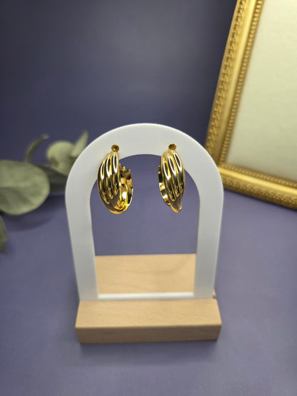 Metric Tides hoops featured on a white arch jewelry stand. These 316 stainless steel waterproof sleeper earrings provide a bold tiered silhouette and a hypoallergenic finish for comfortable wear - My Silver Lining.