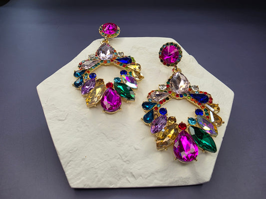 The Deluxe Festival Drop Earrings. Large chandelier-style statement earrings, 7.1 cm long, set with multi-colored crystal glass stones. They feature a Stainless Steel ear needle for comfort.