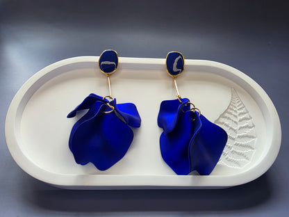 The French Riviera Petal Drop Earrings. Large, 9.2 cm long statement earrings featuring layered acrylic petals in a cascading floral design. Secured with a 316 Stainless Steel ear needle.
