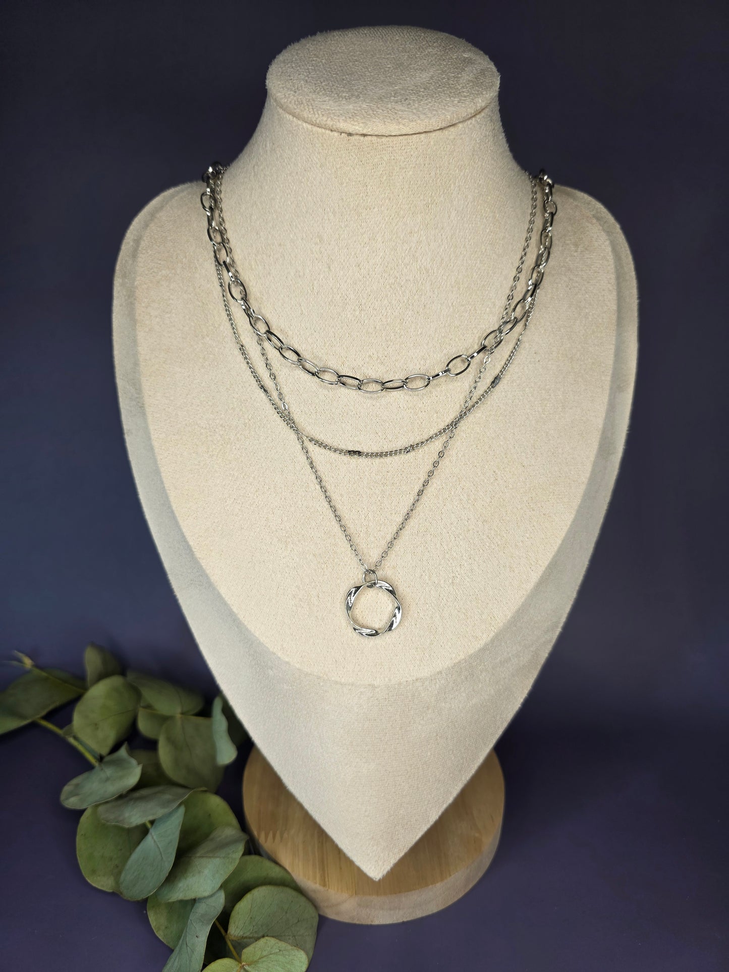 The Silver Line Loop necklace, a single-piece, three-layer necklace set in 925 silver-plated copper. The layers include a chunky oval link chain, a fine chain, and a twisted ring pendant.