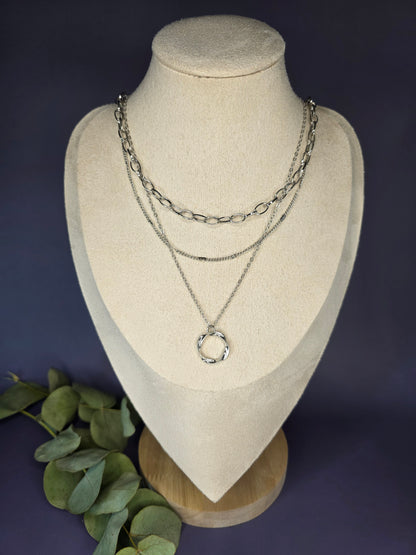 The Silver Line Loop necklace, a single-piece, three-layer necklace set in 925 silver-plated copper. The layers include a chunky oval link chain, a fine chain, and a twisted ring pendant.