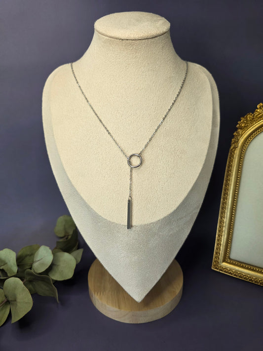 The Sleek Silver Y-Necklace Choker, a stainless-steel lariat necklace featuring a fine chain, a small circular component, and a polished vertical bar drop pendant.