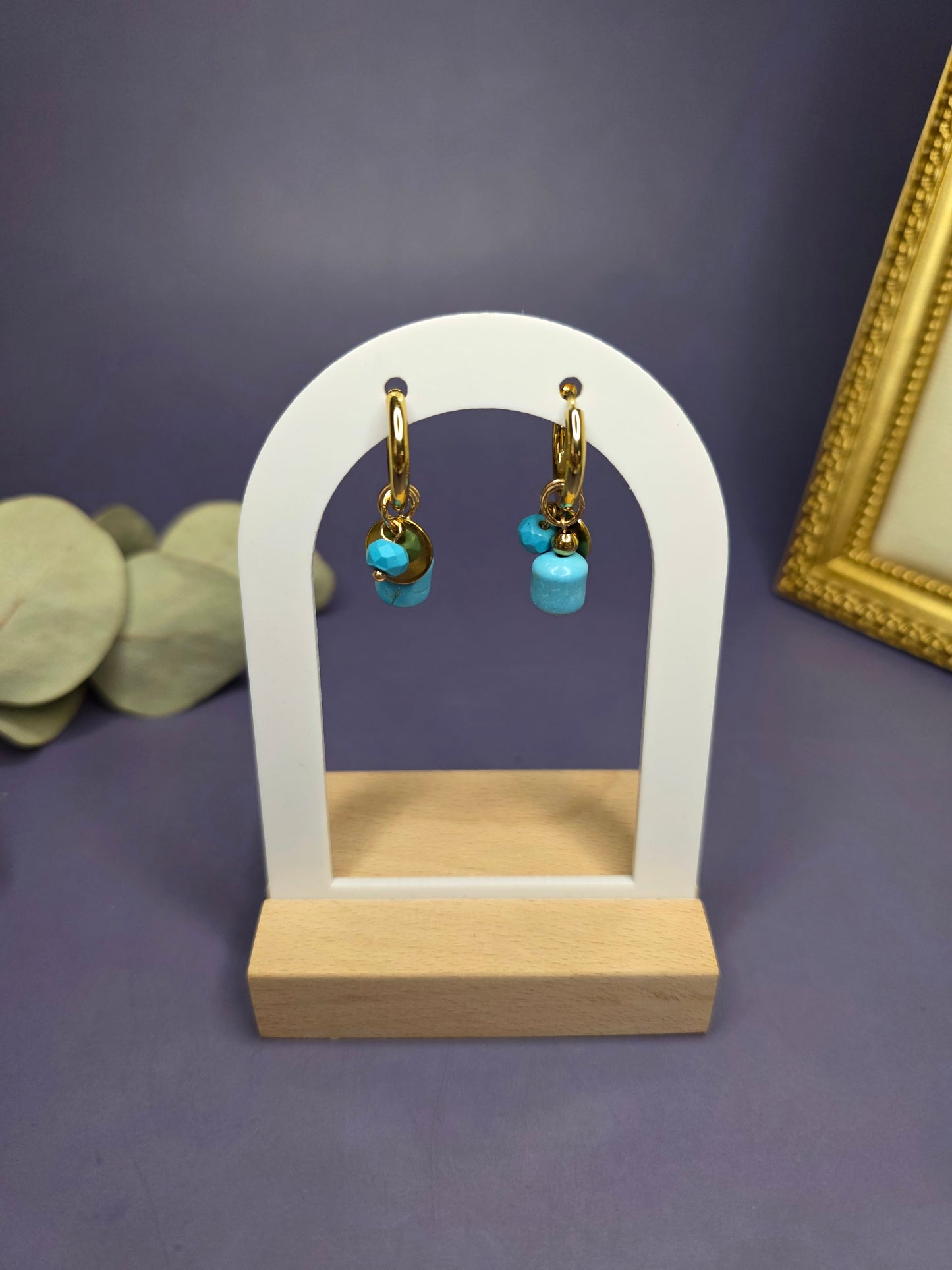 Nomad Turquoise Hoops displayed on a white architectural arch. These 18k gold plated stainless steel earrings feature removable natural-cut turquoise stones — My Silver Lining.