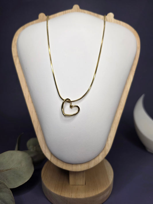 Front view of the Pure Heart Golden Pendant Necklace on a wooden display stand, highlighting the high-quality KC Gold plated 316 stainless steel — My Silver Lining.