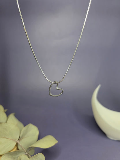 Close-up of the Pure Heart Silver Pendant Necklace in 316 stainless steel, featuring a minimalist open heart design on a silver snake chain — My Silver Lining.
