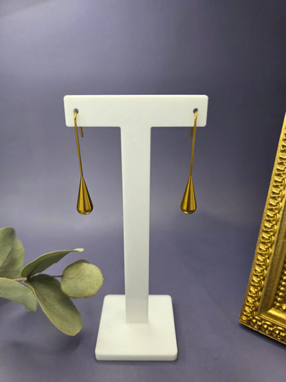 Pair of 18K gold-plated Raindrop Hooks teardrop earrings on a white display stand. High-quality waterproof and tarnish-resistant stainless steel jewelry by My Silver Lining, South Africa.