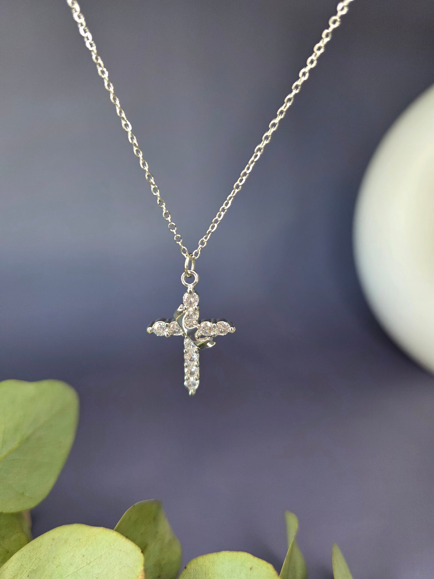 Shimmering Silver Grace necklace shown floating to highlight the pave-set cubic zirconia stones. Tarnish-resistant silver-toned stainless steel cross for sensitive skin - My Silver Lining.