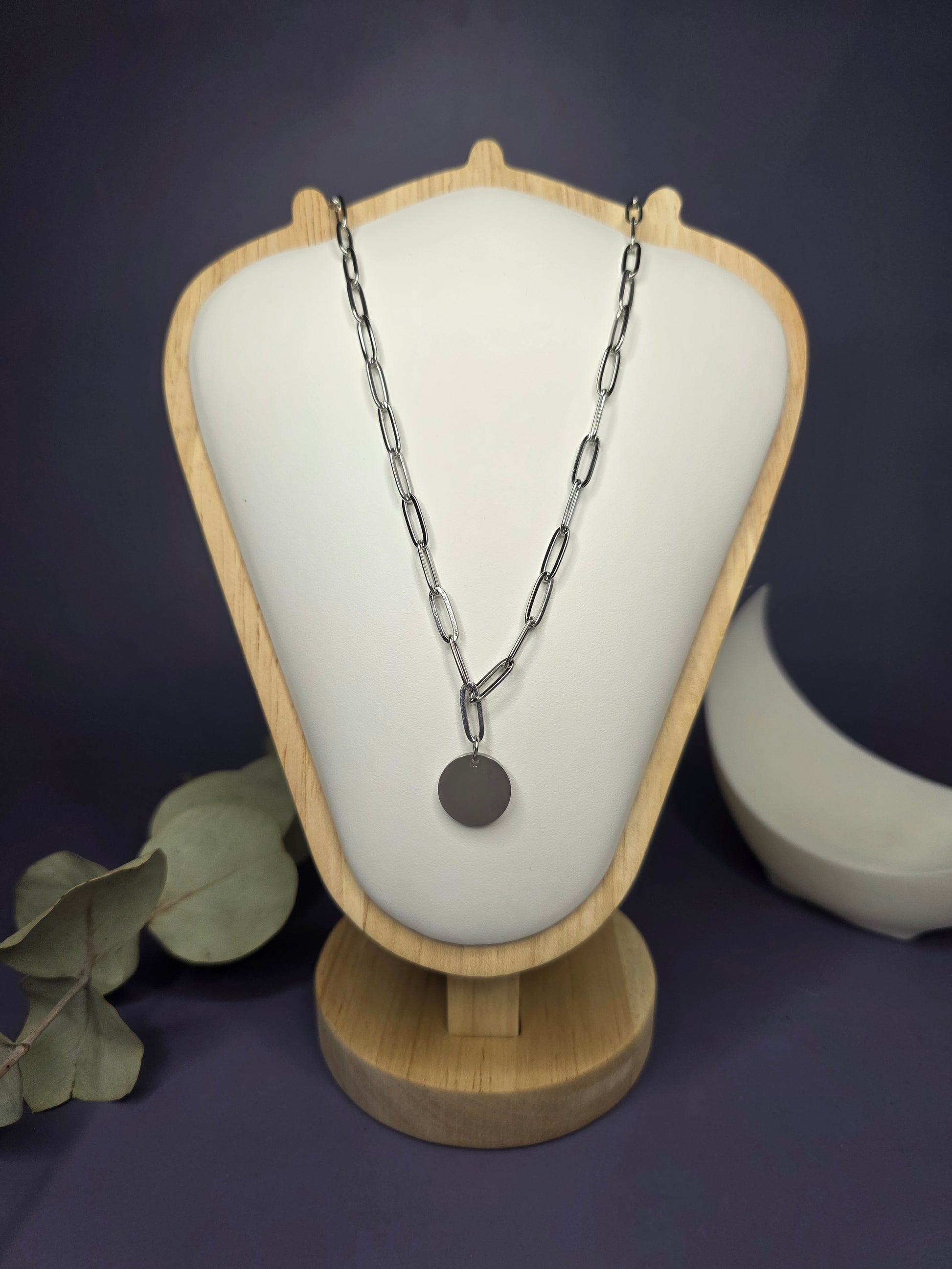 Front view of the Signature Silver Disc Necklace on a jewelry bust, showcasing the polished stainless steel and paperclip chain — My Silver Lining.