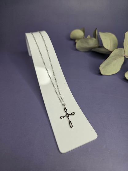 Angled view of the Silver Infinity Cross Necklace on a white display stand — My Silver Lining.