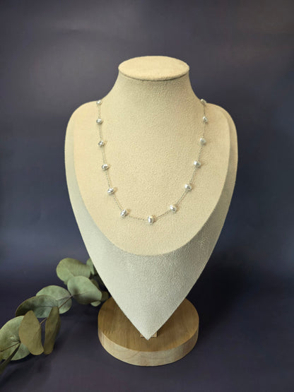 French-inspired silver pearl necklace showcased on a jewelry bust. This waterproof stainless steel piece features elegant faux pearls and a tarnish-resistant finish for chic, Parisian-style everyday wear - My Silver Lining.