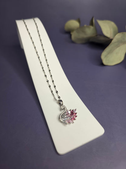 Angled view of the Silver Pink Swan Lake Necklace in polished stainless steel on a white display stand — My Silver Lining.