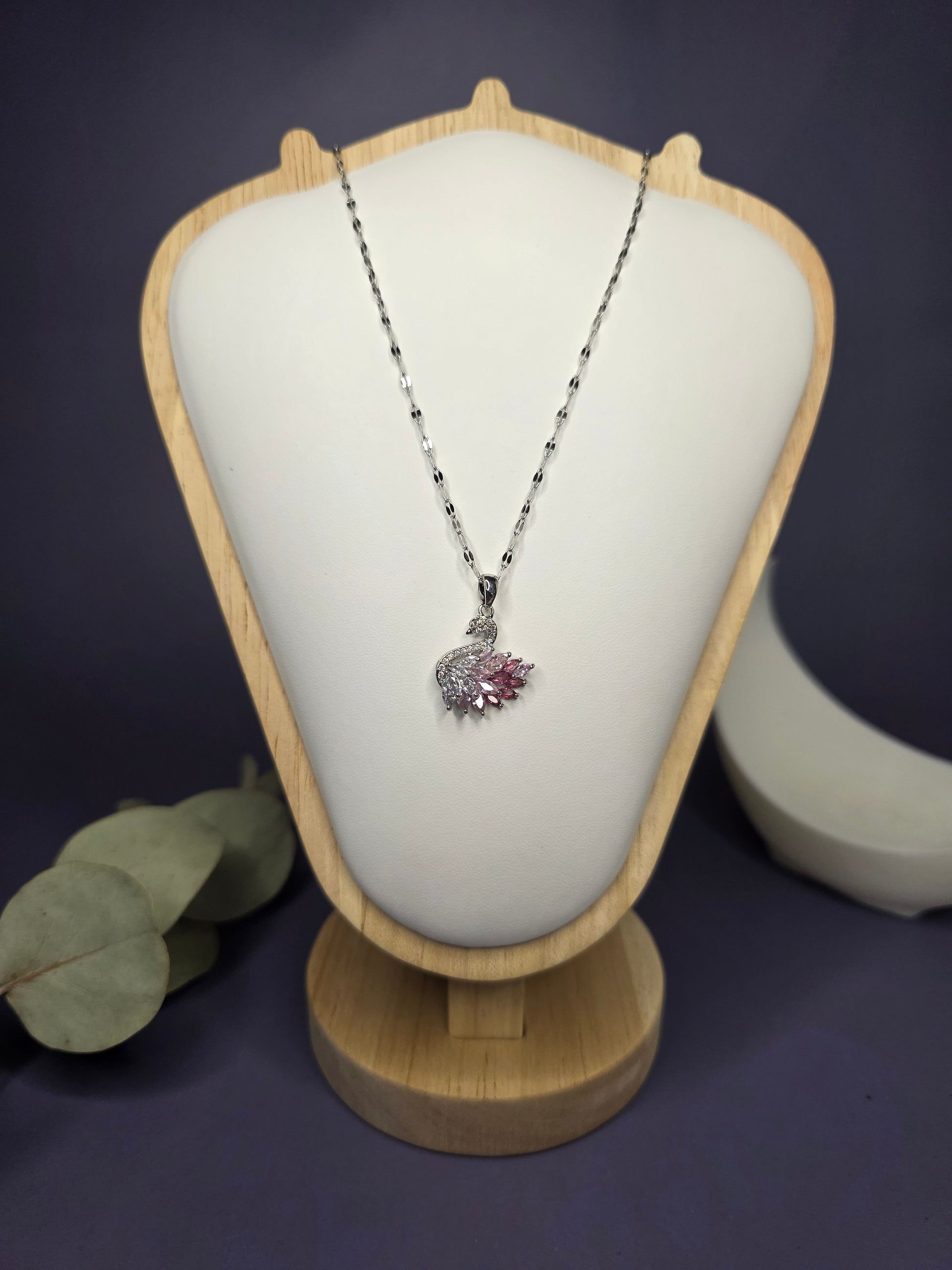 Front view of the Silver Pink Swan Lake zircon pendant on a jewelry bust, showcasing the intricate wing detail — My Silver Lining.