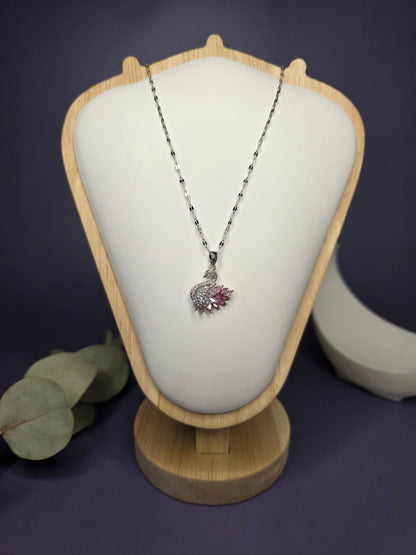 Front view of the Silver Pink Swan Lake zircon pendant on a jewelry bust, showcasing the intricate wing detail — My Silver Lining.
