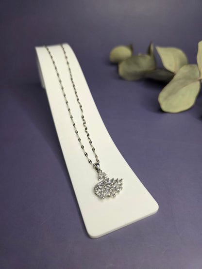 Angled view of the Silver White Swan Lake Necklace in polished stainless steel on a white display stand — My Silver Lining.