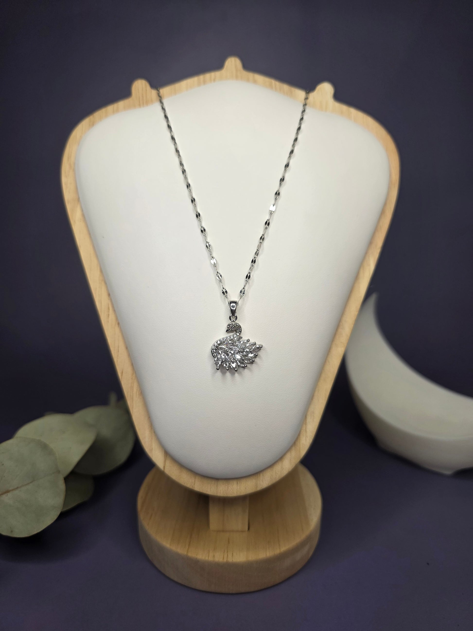Front view of the Silver White Swan Lake zircon pendant on a jewelry bust, showcasing the intricate wing detail — My Silver Lining.