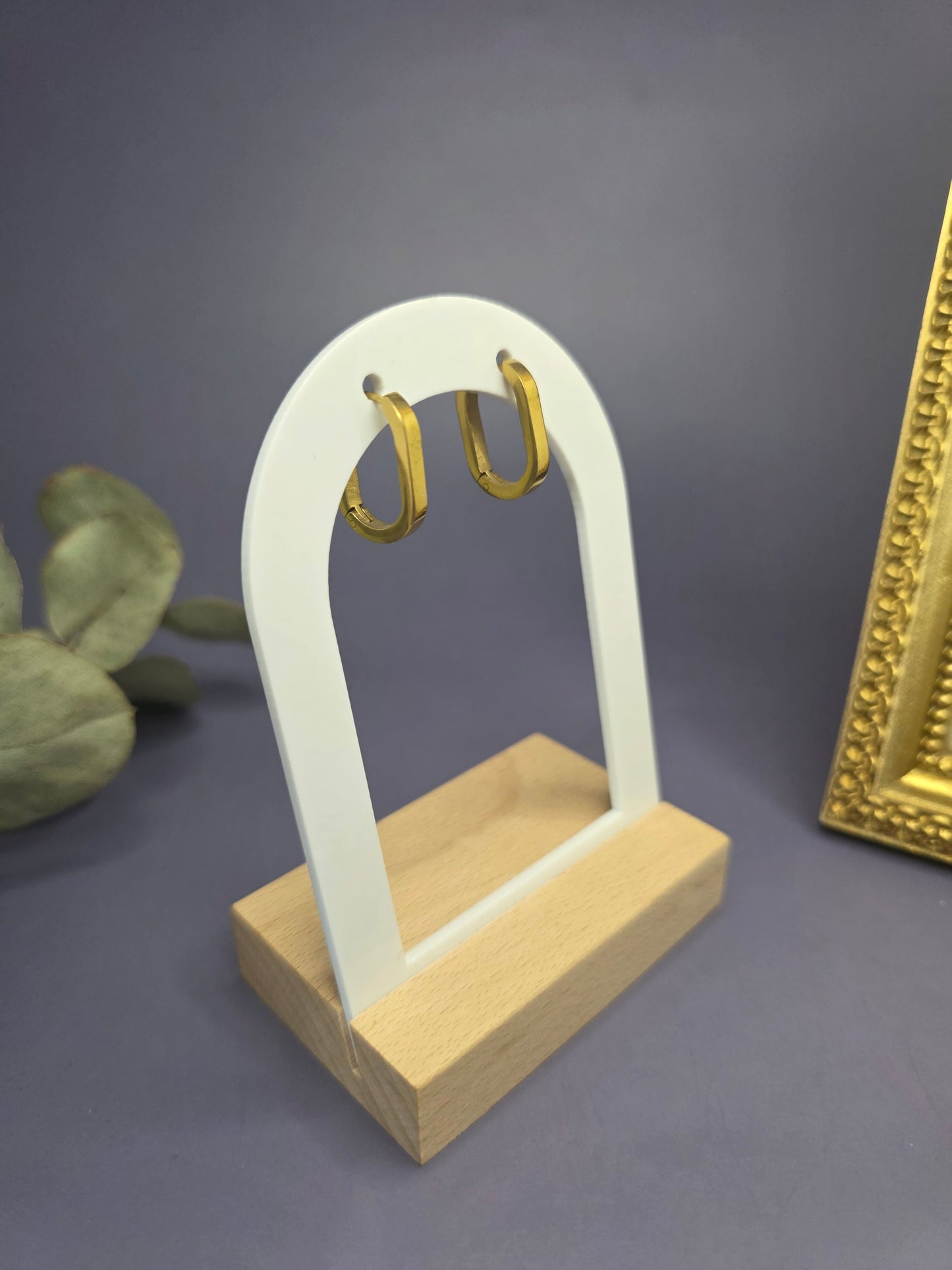 Soft Square golden hoops displayed on a white architectural arch. These KC gold plated sleepers are waterproof, non-tarnish, and designed for sensitive skin — My Silver Lining.