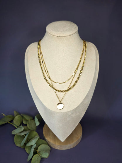 The Luminous Trio layered necklace set styled on a white jewelry bust. This gold plated 3-chain set includes a curb link and disc pendant in waterproof stainless steel - My Silver Lining.
